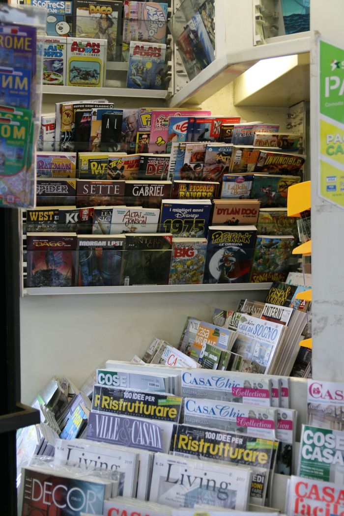 services-03 Colorful selection of comics and magazines at a newsstand in Rome, Italy.